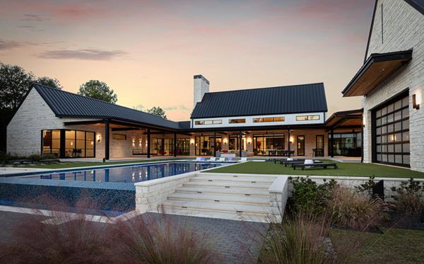Modern farmhouse house and pool with outdoor lighting