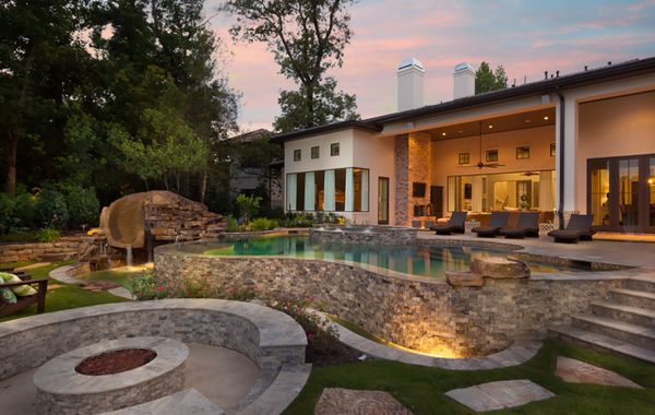 An outdoor pool and entertaining space with backyard lighting