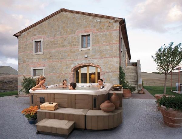 Group of friends in a hot tub in the countryside