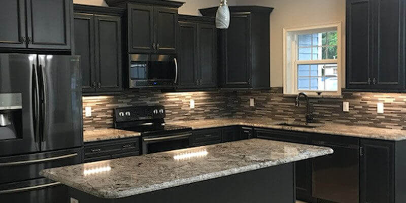 kitchen with black cabinets and appliances
